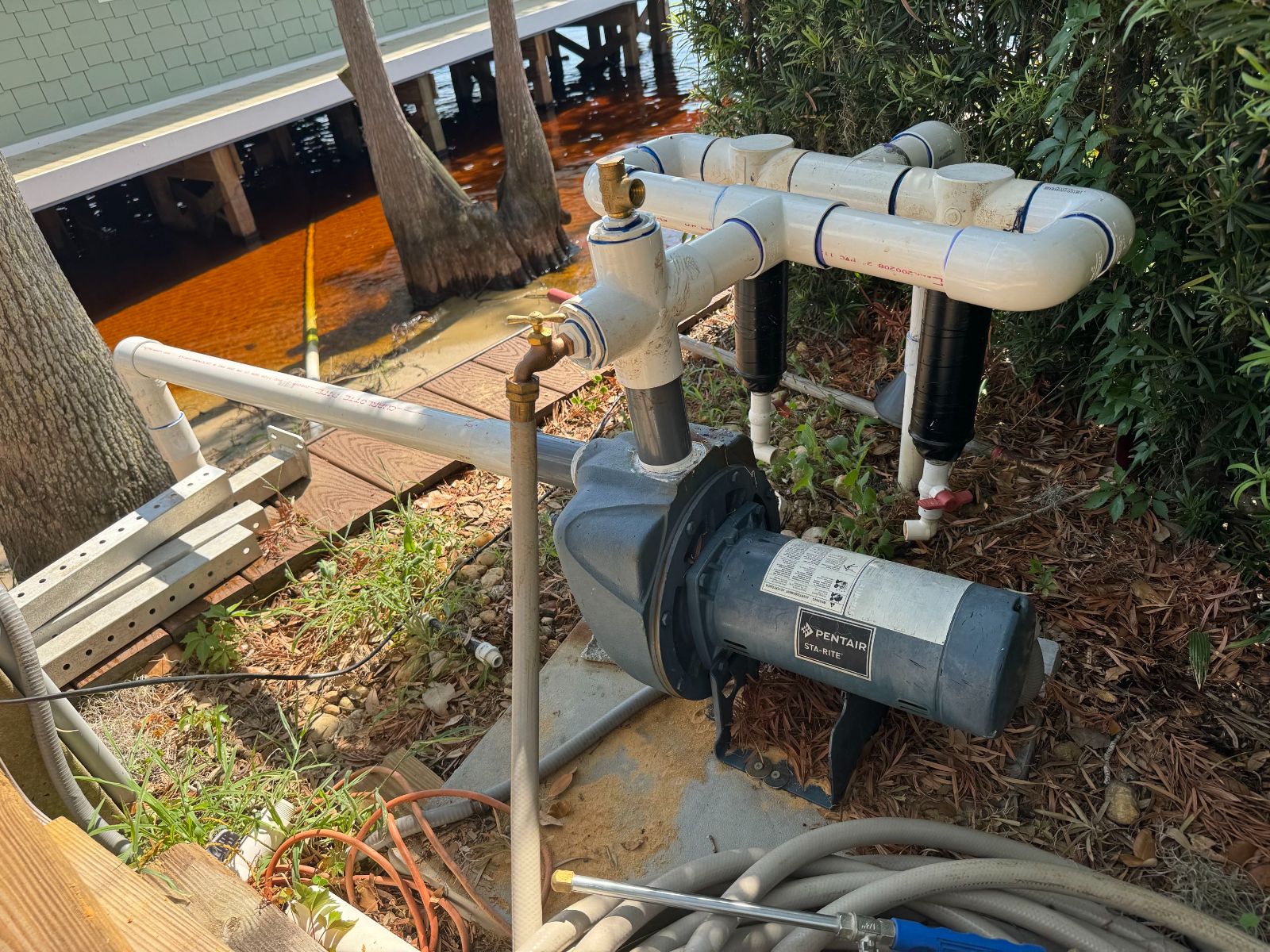 A newly installed irrigation pump mounted beside a fence